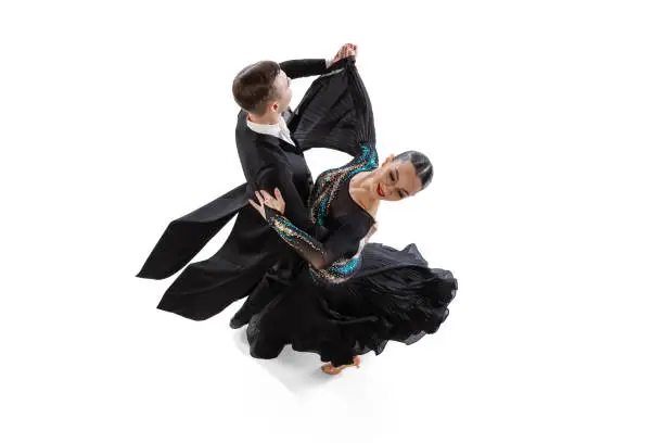 Photo of Top view portrait of young artistic couple dancing waltz isolated over white studio background