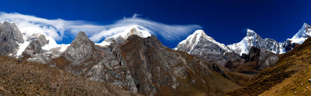 Panorama of snowy mountains and valley in the remote Cordillera Huayhuash Circuit near Caraz in Peru. stock photo