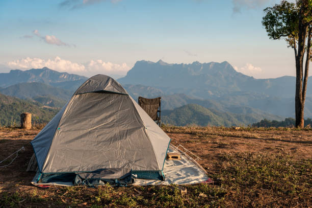 istock Tent camping on hill with mountain range in national park 1368226885