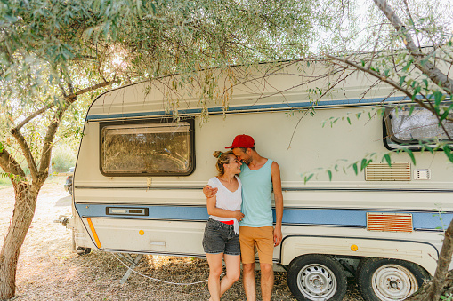 Photo of a happy couple having precious moments during their RV vacation