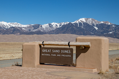 Great Sand Dunes National Park with snowcapped mountain background in southern Colorado, United States of America (USA). Nearest town is Alamosa, Colorado. A sandbox of epi proportions, the entire dune field encompasses 30 square miles and the tallest dune towers 750 feet high.