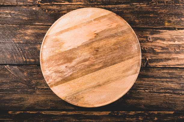 istock Wooden plate on wooden background 1368228822