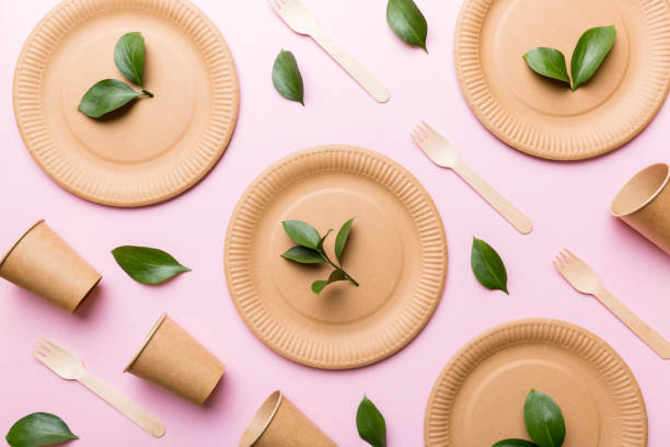 istock set of empty reusable disposable eco-friendly plates, cups, utensils on light white colored table background. top view. Biodegradable craft dishes. Recycling concept. Close-up 1368228945