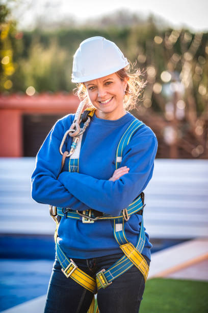 istock Female Worker putting on safety harness 1368229222
