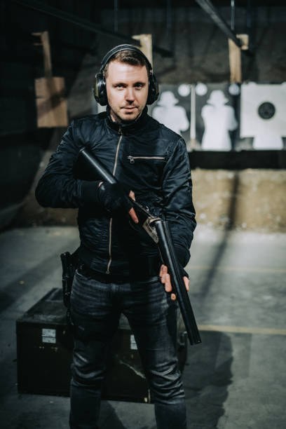 istock Soldier training on a shooting range. Posing with Lupara sawed off shotgun 1368232892