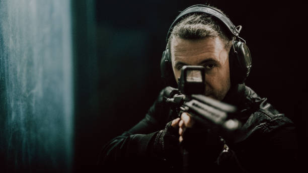 istock Sniper's training on a shooting range. Aiming with M4 AR-15 rifle towards camera 1368232974