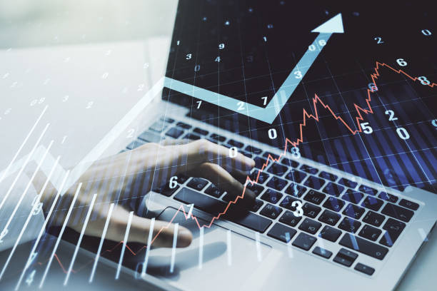 istock Abstract creative financial graph with upward arrow and hands typing on laptop on background, financial and trading concept. Multiexposure 1368233772