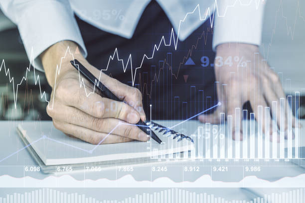istock Abstract creative financial graph with hand writing in notebook on background, forex and investment concept. Multiexposure 1368233808