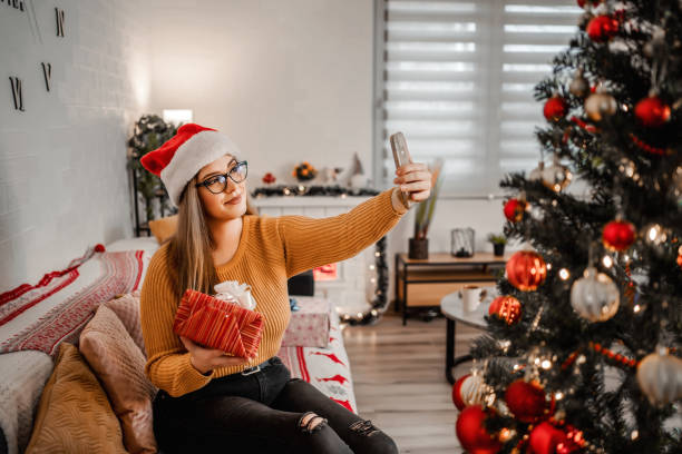 istock Happy brunette smiling while talking on a video call and saying thanks for her Christmas present 1368233956