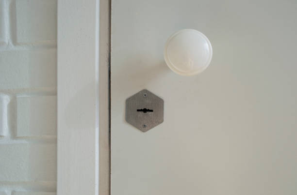 istock Closed white wooden door with lock and handle. 1368236290