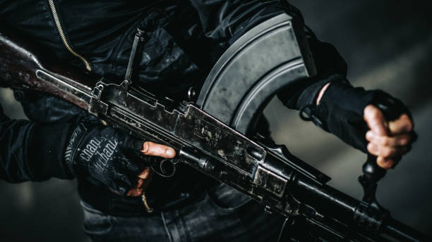 istock Shooting preparations. Man holding Bren light machine gun 1368238559