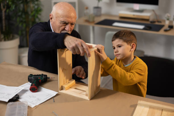 istock Grandfather passing on a skill to grandson 1368238829
