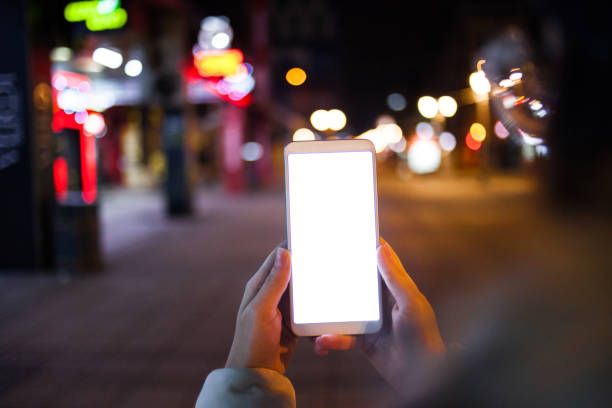 istock Using the phone in the city at night 1368239176