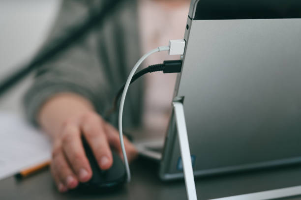 istock Gray laptop being charge 1368241120