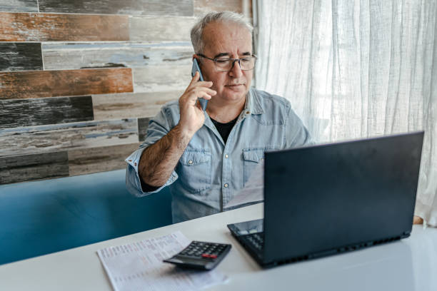 istock Senior Man planning home budget and using calculator 1368241566