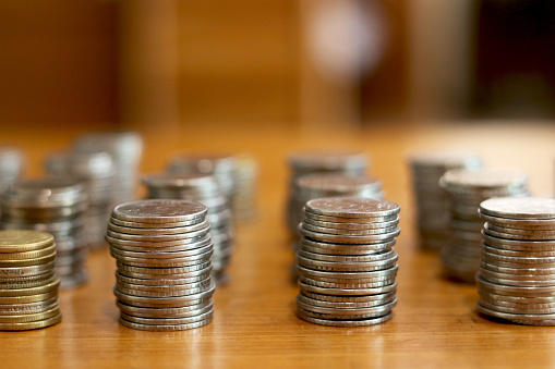 group of stack currency coins on table - Image