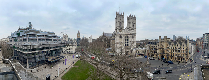 Panoramic view of Westminster Abbey in the setting of Parliament Square , House Of Parliament and Queen Elizabeth II Conference Centre on the left. London, UK