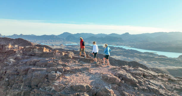 Aerial view, hikers follow route along desert ridge crest