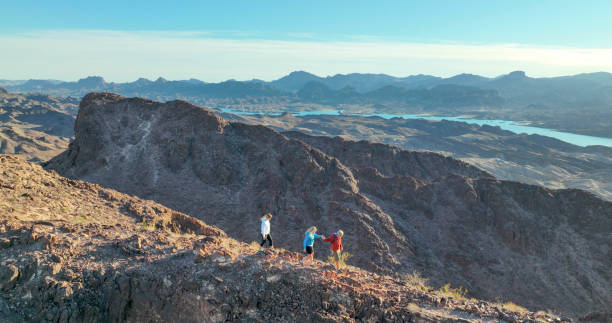 istock Aerial view, hikers follow route along desert ridge crest 1368243023