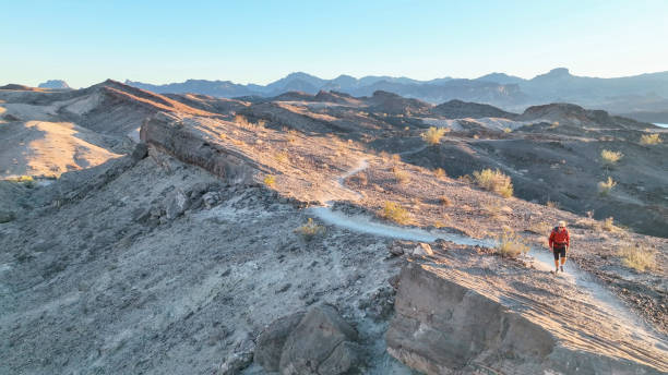 istock Aerial view, hiker follows route along desert ridge crest 1368243903