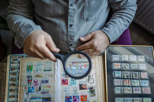 Photo of Senior Man collecting stamps from around the world