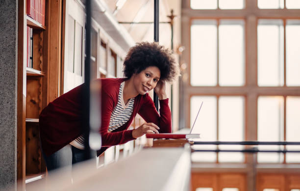 istock Young woman studying in the library 1368245309
