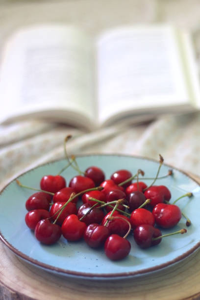 istock Plate of Cherries and Open Book 1368245430