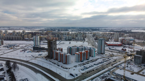 istock Construction site of a modern city block. High-rise buildings under construction. Construction tower cranes. Construction site in winter. Aerial photography at sunset. 1368245743