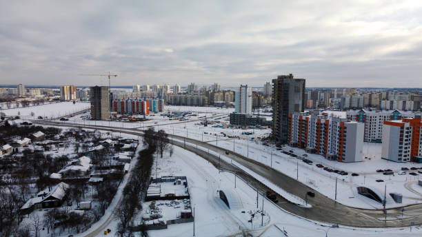 istock Construction site of a modern city block. High-rise buildings under construction. Construction tower cranes. Construction site in winter. Aerial photography at sunset. 1368245748