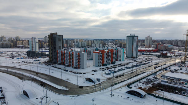 istock Construction site of a modern city block. High-rise buildings under construction. Construction tower cranes. Construction site in winter. Aerial photography at sunset. 1368245750
