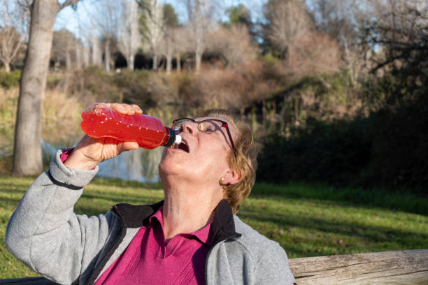 istock woman drinking an isotonic drink 1368246858
