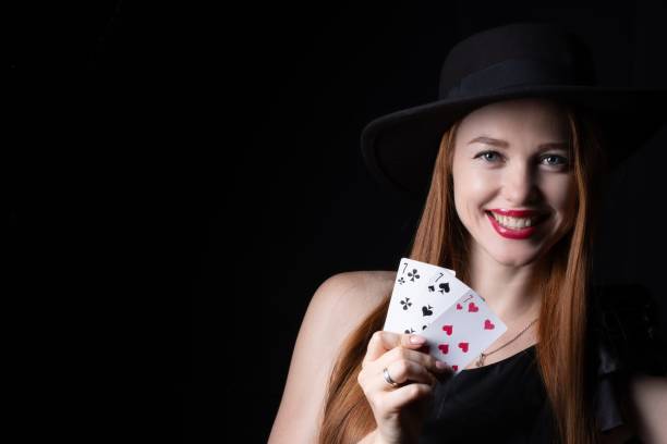 istock a girl in a hat with playing cards three sevens on a black isolate 1368246934