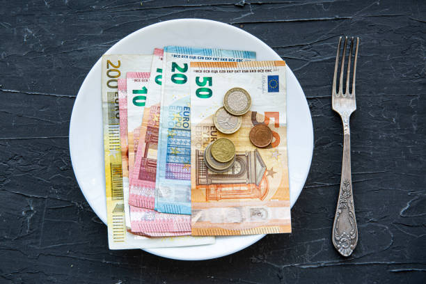 istock Money spend concept, euro and coins on black backgorund. 1368247268