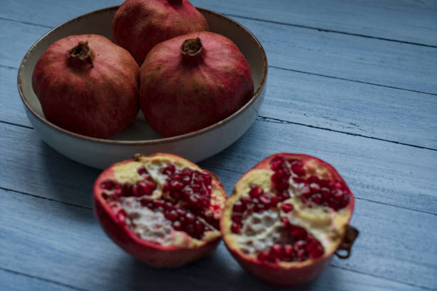 istock Ripe pomegranate fruit on wooden background 1368247341