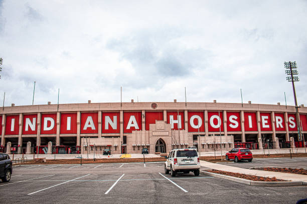 Side view of Hoosier Indiana Football stadium and ticket offices with parking lot in foreground and a few parked cars - Copy space. 2021-03-26-Bloomington Indiana USA - Side view of Hoosier Indiana Football stadium and ticket offices with parking lot in foreground and a few parked cars - Copy space. indiana university bloomington football stock pictures, royalty-free photos & images