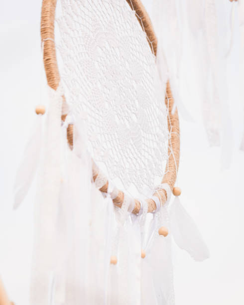 istock White cotton dreamcatcher at natural background, soft selective focus, toned 1368248335