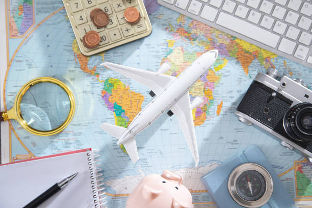 istock Calculator, coins, retro camera, airplane on the world map. 1368248665