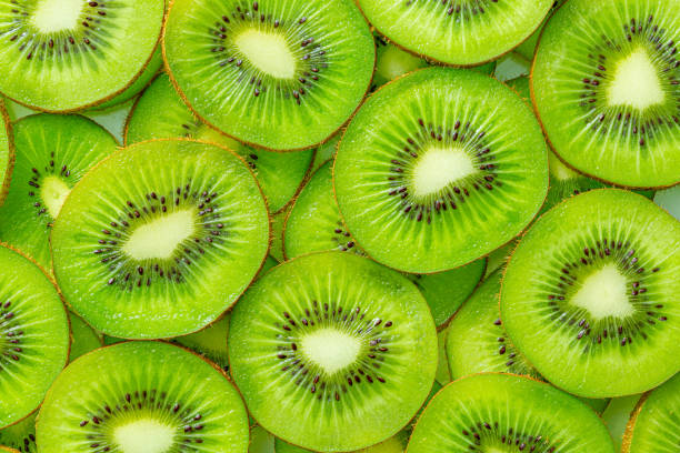 istock Sliced kiwi as textured background ,Fresh Kiwi fruit sliced use for background 1368249629