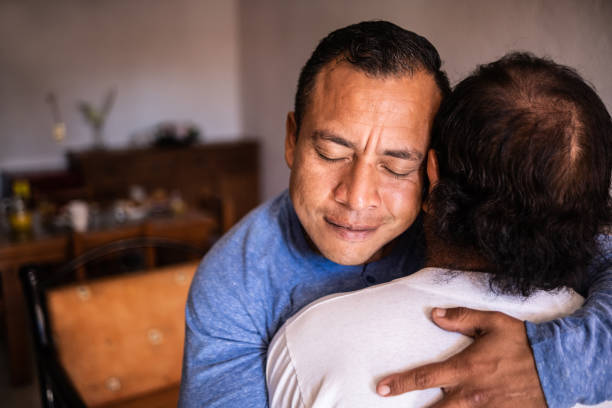 istock Latin father and son hugging each other at home 1368249780