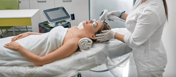 istock Female patient wearing protective eyeglasses while photorejuvenation procedure with intense pulsed light IPL at medical clinic 1368250798