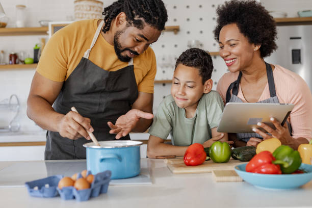 istock Family preparing a healthy meal in the kitchen 1368250815