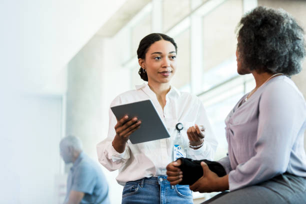 istock Therapist uses tablet to update woman's electronic medical record 1368252338