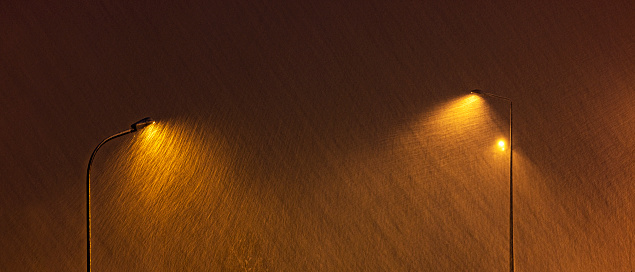 In the night snowfall under streetlights