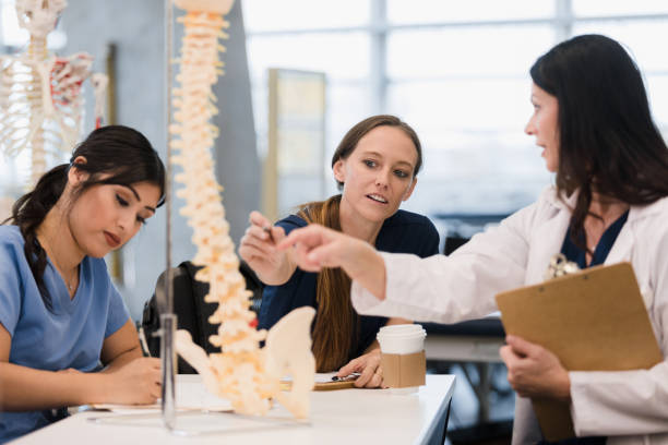 istock Female professor works with two nursing students 1368253315