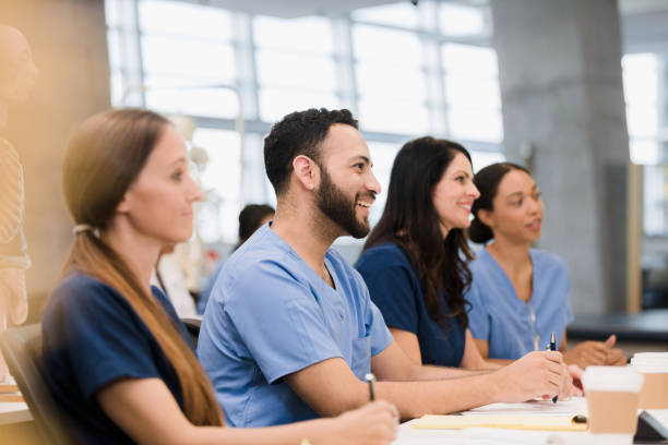 istock Multi-ethnic nursing students sit and listen to unseen teacher 1368253347