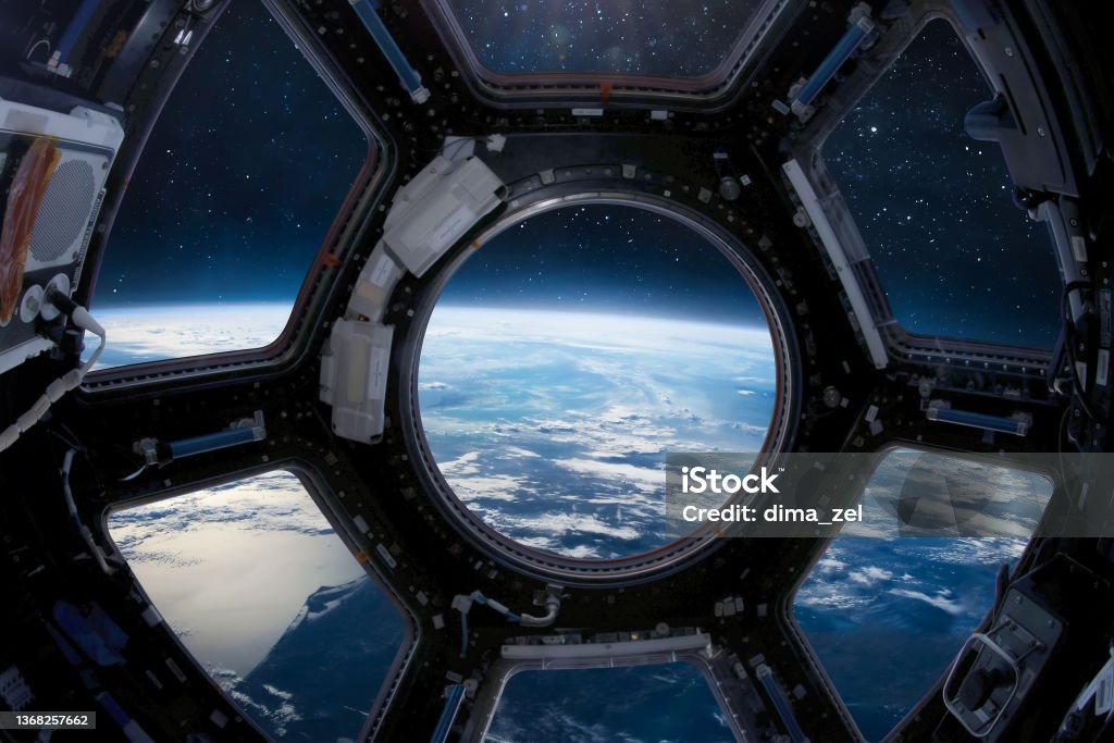 Cupola porthole on ISS orbital station. International space station. Orbit and deep space with stars view from porthole. Spaceship and blue planet. People in sapce. Elements of this image furnished by NASA Earth planet view from ISS porthole. View from Cupola. International space station. Orbit and deep space with stars. Spaceship. Elements of this image furnished by NASA (url: https://www.nasa.gov/sites/default/files/styles/full_width_feature/public/thumbnails/image/iss043e284928.jpg https://www.nasa.gov/sites/default/files/styles/full_width_feature/public/thumbnails/image/iss063e074377.jpg) Outer Space Stock Photo