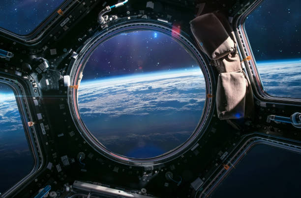 earth planet view from iss porthole. view from cupola. international space station. orbit and deep space with stars. spaceship. elements of this image furnished by nasa - nasa stockfoto's en -beelden