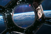 Earth planet view from ISS porthole. View from Cupola. International space station. Orbit and deep space with stars. Spaceship. Elements of this image furnished by NASA