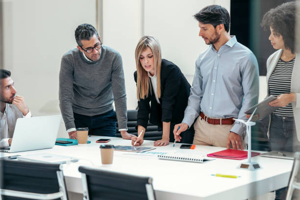 istock Successful business team standing around computer for presentation of work in a modern startup. 1368257936
