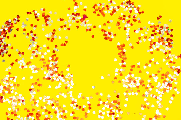 istock red and white heart shape confetti on yellow background. valentine's day 1368257981